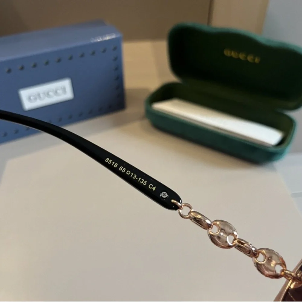 Gucci Women's Black and Gold Sunglasses